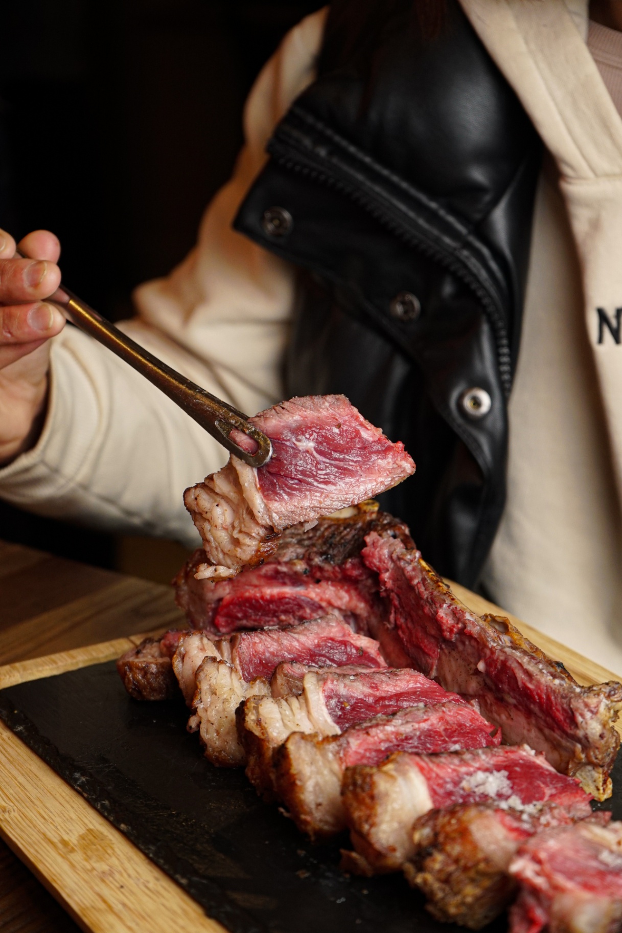 Dry-aged steak sliced over the grill